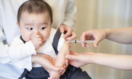 Vaccinated baby and mother hugging